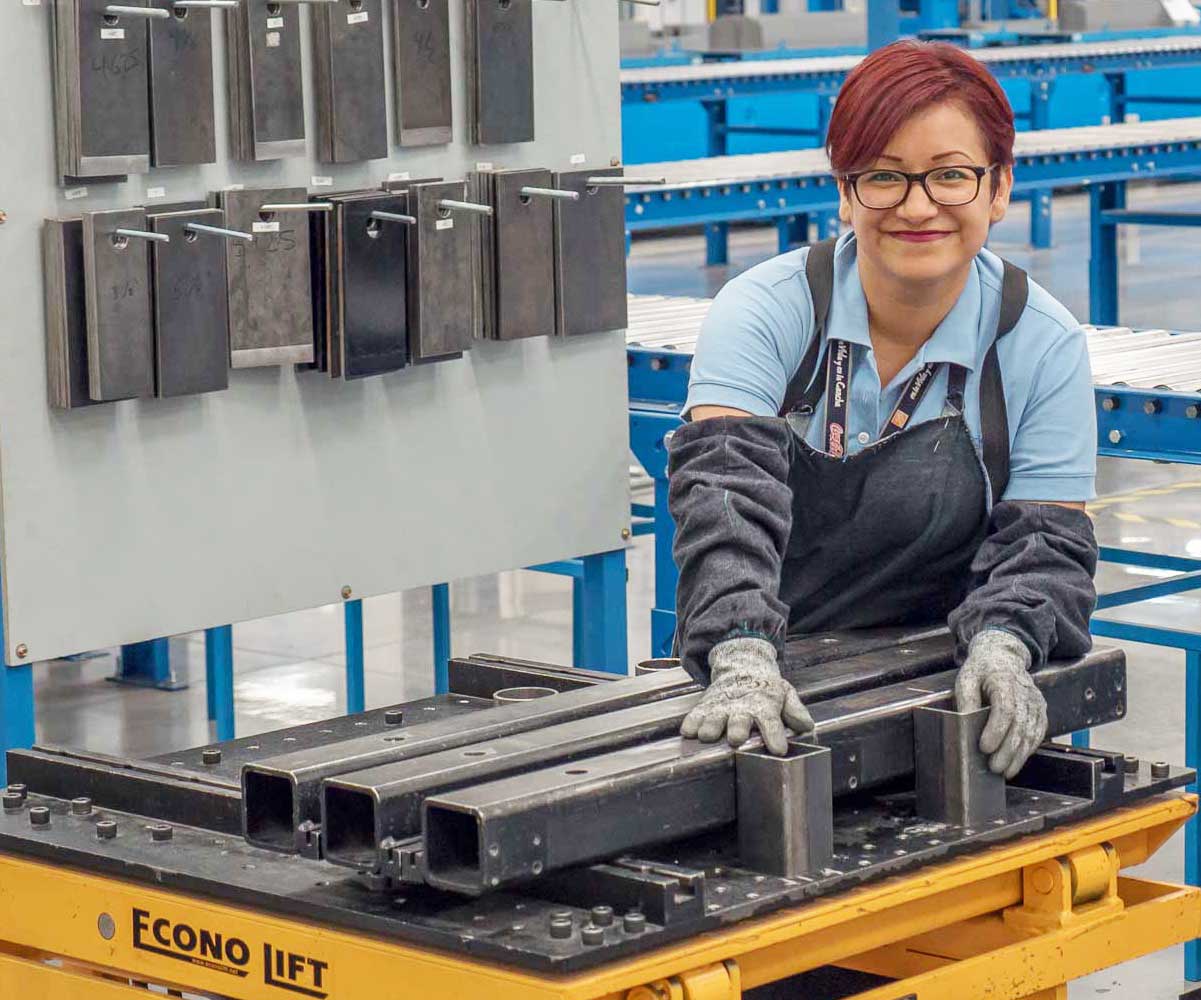 Corefficient employee working at a Corefficient facility and smiling for the camera.