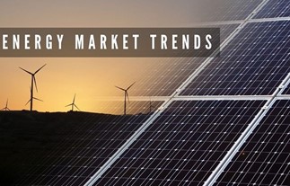 A picture of a sunset behind several windmill silhouettes on a horizon. On the right side is a transparent picture of a dark blue and white solar panel. On the top left is a brown graphic rectangle with the words, “ENERGY MARKET TRENDS.”