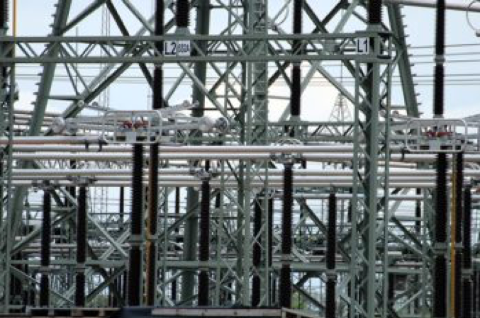 Exterior view of power transformers on a sunny day.